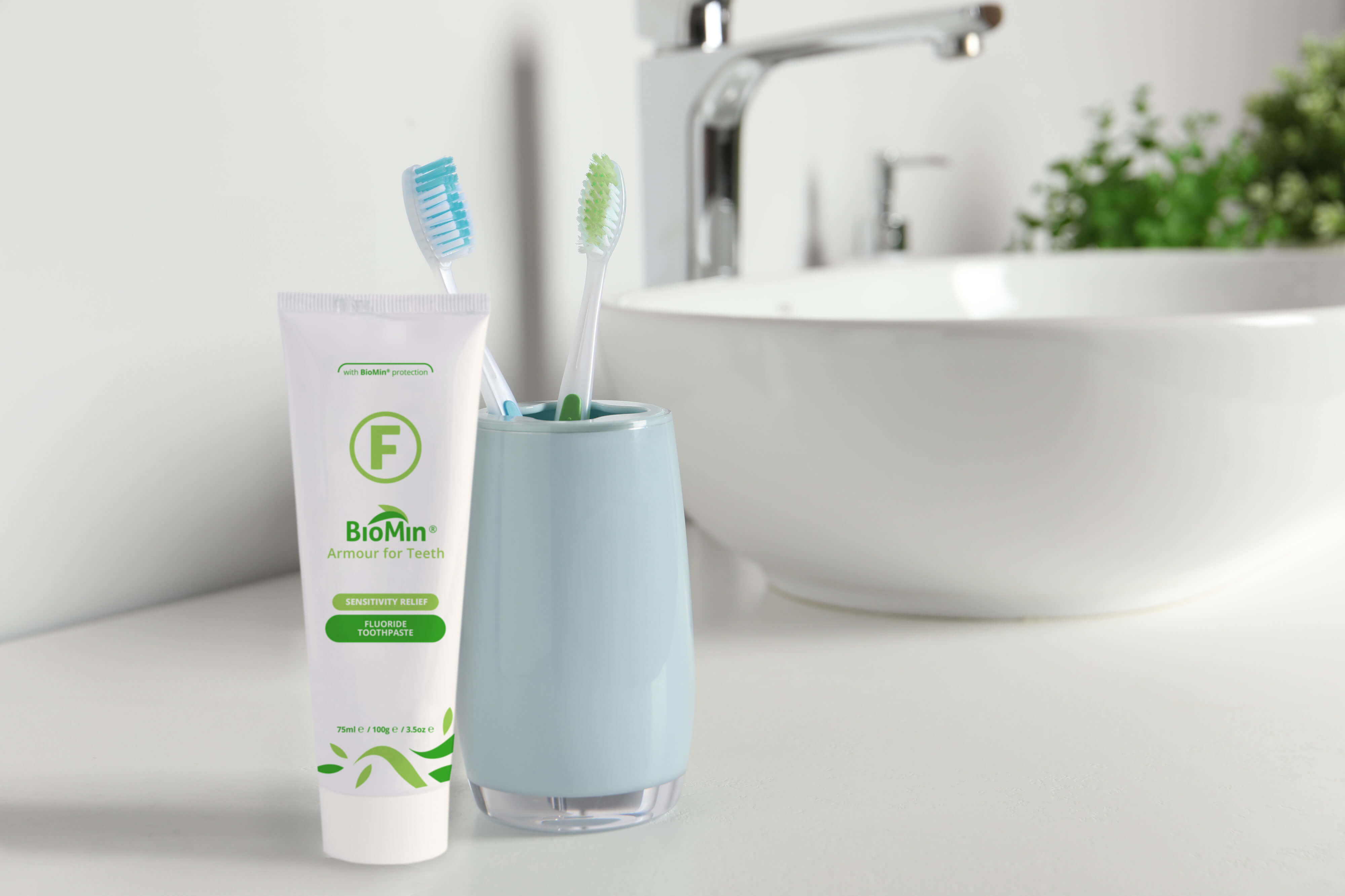 BioMin F toothpaste next to a sink and toothbrushes.
