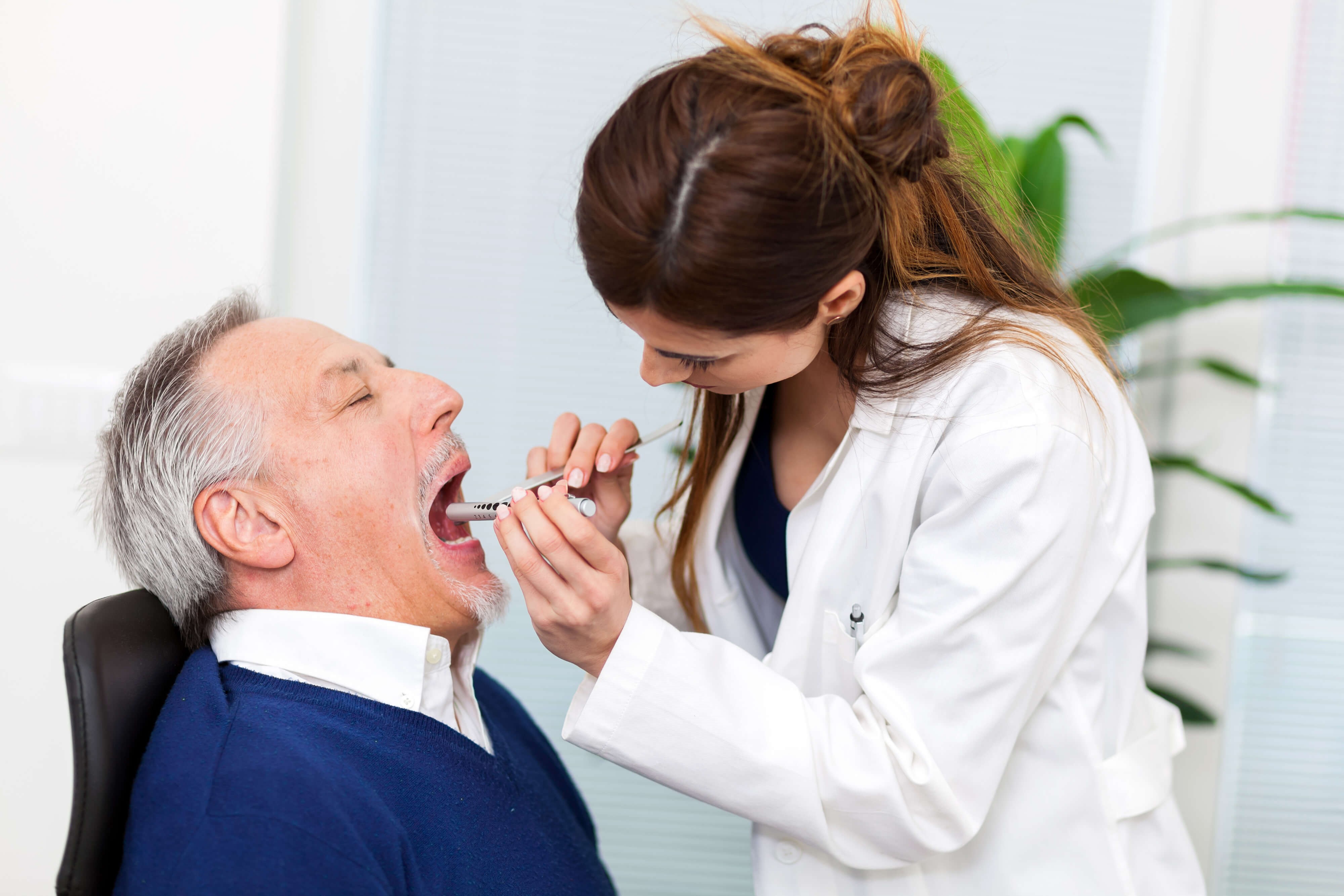 Doctor checking a patients oral health
